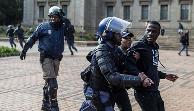A student is detained by anti-riot police as they disperse a demonstration over fee increases at the Witwatersrand University in Johannesburg on Tuesday.