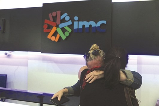 IMC TV employees comfort each other after the broadcasteru2019s transmission was cut by the authorities.