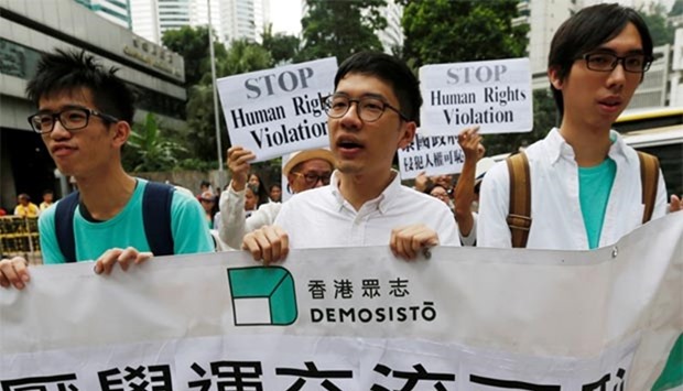 Pro-democracy activist Nathan Law (centre) from Demosisto marches with other protesters to the Thai Consulate in Hong Kong on Wednesday to protest against Thailand's decision to bar activist Joshua Wong from entering Bangkok.
