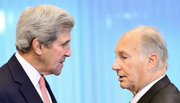 US State Secretary John Kerry speaks with the Aga Khan (Prince Shah Karim Al Husseini Aga Khan IV) as they attend the Conference on Afghanistan at the European Council in Brussels on Wednesday.