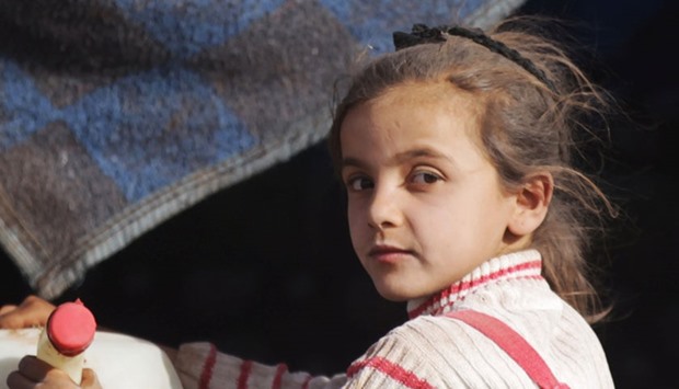 A girl who fled from Islamic State-controlled areas rides a pick-up truck to the northern Syrian rebel-held town of al-Rai, in Aleppo Governorate, Syria, October 3, 2016