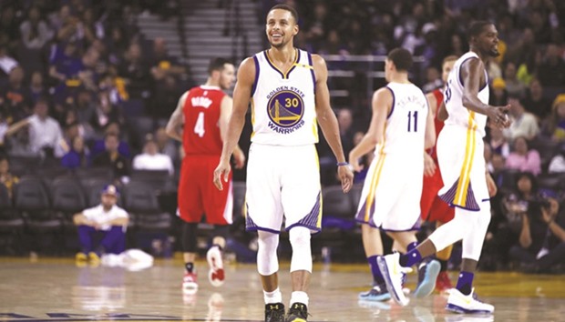 Stephen Curry #30 of the Golden State Warriors smiles during their preseason game against the Los Angeles Clippers at Oracle Arena in Oakland, California.