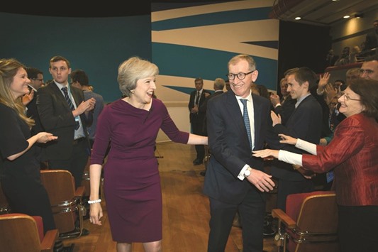 Prime Minister Theresa May and her husband Philip leave the stage after her keynote address.