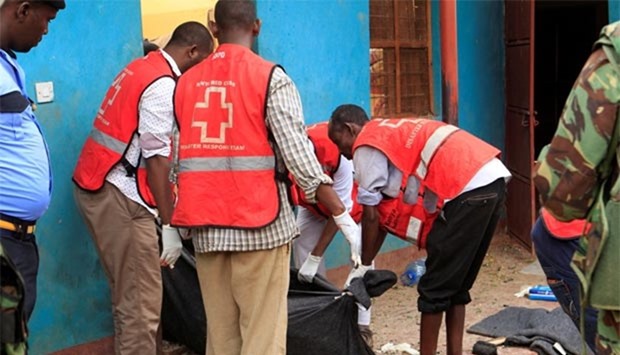 Kenya Red Cross workers move a body after an attack by Shabaab militants in Mandera on Thursday.