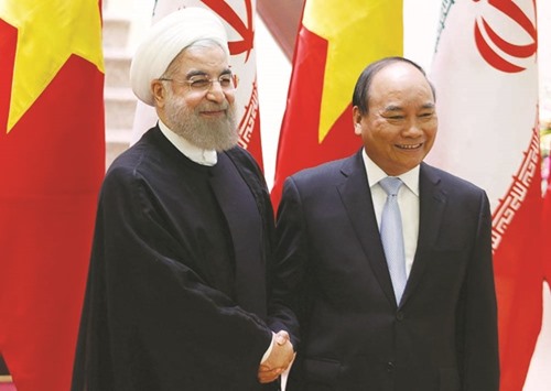 Iranu2019s President Hassan Rouhani (left) with Vietnamu2019s Prime Minister Nguyen Xuan Phuc at the Government Office in Hanoi yesterday. u201cThe two sides agreed to increase bilateral trade turnover to $2bn,u201d the Iranian president told reporters.