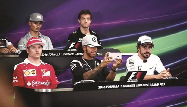 Mercedes driver Lewis Hamilton of Britain (centre, front) records video footage using his smartphone during a press conference with (from left to right) Scuderia Ferrariu2019s Finnish driver Kimi Raikkonen, Manoru2019s Racingu2019s German driver Pascal Wehrlein, Renault Sport F1 Teamu2019s British driver Jolyon Palmer, and McLaren Hondau2019s Spanish driver Fernando Alonso ahead of the Formula One Japanese Grand Prix in Suzuka yesterday. (AFP)