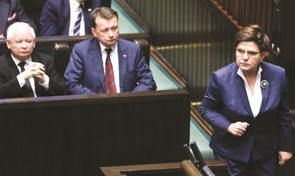 Prime Minister Beata Szydlo (right), PiS party leader Jaroslaw Kaczynski (left) and Minister of Interior and Administration Mariusz Blaszczak are seen in parliament yesterday, during which a near-total abortion ban was rejected following nation-wide protests.