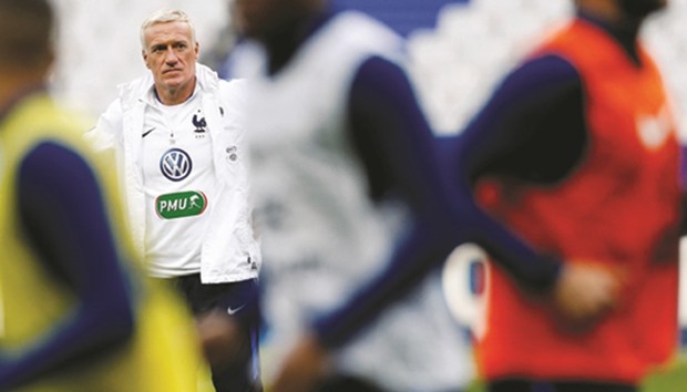 Franceu2019s head coach Didier Deschamps watches his players during a training session in Saint-Denis near Paris yesterday. (Reuters)