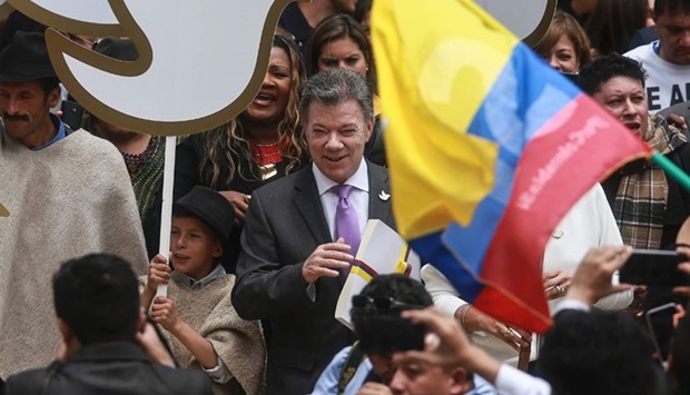 Colombian President Juan Manuel Santos carrying a copy with the final text of the peace agreement with the Revolutionary Armed Forces of Colombia (FARC) guerrillas, on his way from the presidential palace to the National Congress in Bogota, on August 25, 2016.