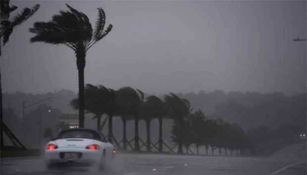 A motorist drives in heavy rain and wind in Atlantic Beach, Florida on Friday, as Hurricane Matthew approaches the area.