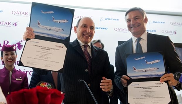 Akbar al-Baker, CEO of Qatar Airways, and Ray Conner, President and CEO of Boeing Commercial Airplanes, hold up commemorative certificates of purchase after announcing a deal for 100 airplanes in Washington, DC, on Friday.