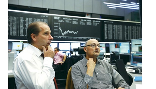 Traders work at the Frankfurt Stock Exchange. The DAX 30 closed down 0.7% to 10,490.86 points yesterday.