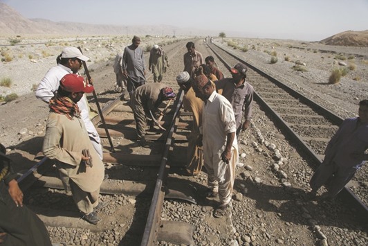 Workers repair damaged rail tracks after a bomb blast attack on a train near the town of Much in southeast of Quetta yesterday.