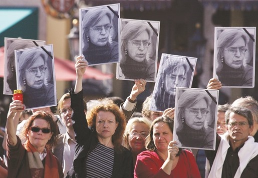 This file photo taken on October 11, 2006 shows protesters with portraits of Politkovskaya outside the Residenz palace complex in central Munich during Vladimir Putinu2019s welcoming ceremony.