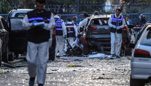 Forensic officers work at the scene of a blast near a police station in Istanbul on October 6, 2016