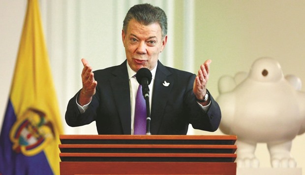 President Juan Manuel Santos acknowledging the applause while addressing people who worked for the peace accord to be approved in the recent referendum, after winning the Nobel Peace Prize, at Narino Palace in Bogota, yesterday.