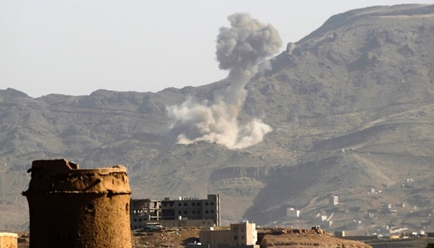 Smoke billows in the distance following a reported air strike carried out by the Saudi-led coalition in the Yemeni capital Sanaa on October 5, 2016