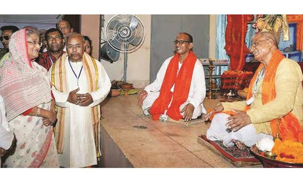 Prime Minister Sheikh Hasina talking to a priest of a temple in Dhaka yesterday.