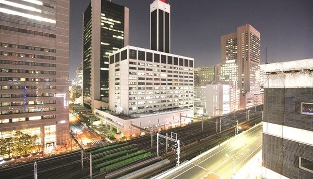 Tokyo Electric Power Company headquarters, (centre), is seen at night in Tokyo. Tepco is still struggling to put the Fukushima nuclear disaster behind it, admitting that paying for decommissioning the plant in one go risks leaving it insolvent.