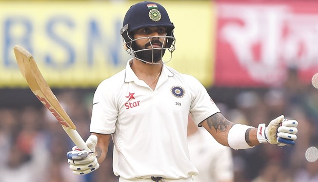 Indian captain Virat Kohli celebrates after reaching his 13th Test century during the first day's play of the third Test at the Holkar Stadium in Indore yesterday. (AFP)