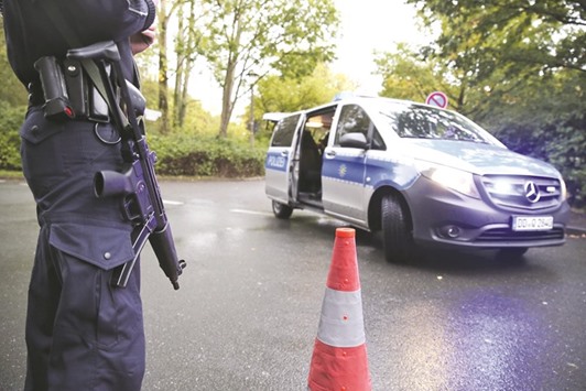 A police officer mans a check point at a housing area in the eastern city of Chemnitz.