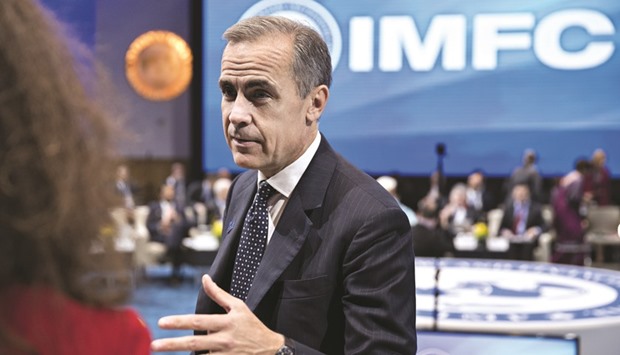 Mark Carney, governor of the Bank of England, speaks to an attendee during an IMF Committee governorsu2019 plenary session at the IMF and World Bank Group Annual Meetings in Washington, DC, yesterday. u201cThe global economy has benefited tremendously from globalisation and technological change. However, the outlook is increasingly threatened by inward-looking policies, including protectionism, and stalled reforms,u201d the IMFu2019s top advisory panel said in a communique released after meetings.