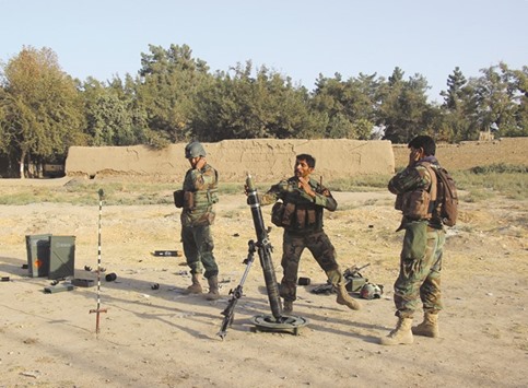 Afghan soldiers fire a mortar round at Taliban positions during a battle with rebels in Kunduz province yesterday.
