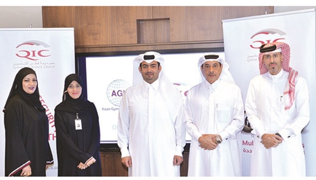 QIC and AGU officials after the signing ceremony held at West Bay.