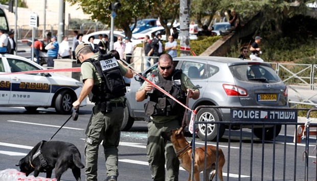 Israeli police secure the area following a shooting incident in what an Israeli police spokesperson described as a terrorist attack, near police headquarters in Jerusalem.