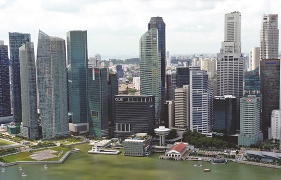 Skyscrapers are seen in Singapore. On the surface, the property markets in Singapore and Hong Kong have much in common. The two Asian financial hubs have both moved to rein in runaway home prices in recent years as they sought to make housing more affordable.