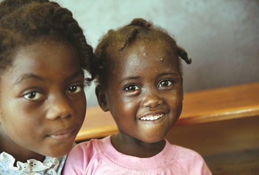 Children pose for a photograph at a shelter set up at a school in Jeremie, Haiti.