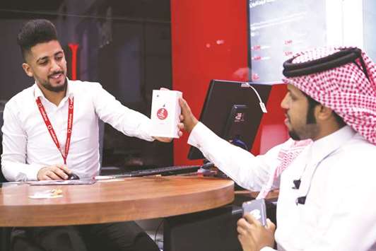 A customer receives his new handset from Vodafone.