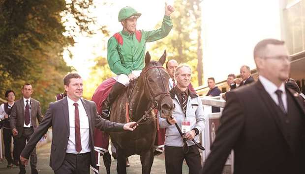 Vazibarad, with Christophe Soumillon astride, is led in to the winneru2019s enclosure after the Qatar Prix Du Cadran (Group 1) in Chantilly, France, yesterday.