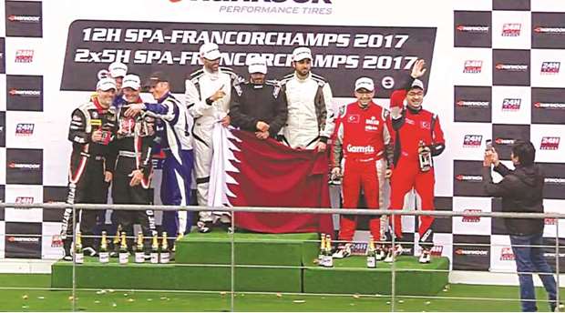 Qatar teamu2019s Abdullah al-Khulaifi, Mahmoud al-Khalaf and Mansour al-Hajri celebrate on the podium of the 12-hour world championship tour for endurance racing at the Circuit de Spa-Francorchamps motor racing circuit in Belgium.