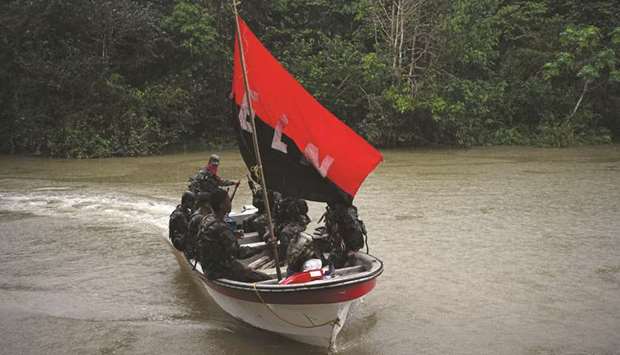 Rebels of Colombiau2019s Marxist National Liberation Army (ELN) arrive in a boat in the northwestern jungles of Colombia.