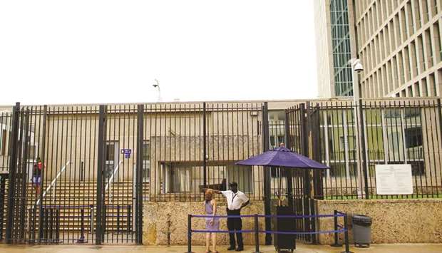 A woman asks for information at the entrance of the US embassy in Havana.