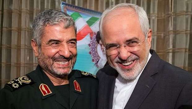 Islamic Revolutionary Guard Corps (IRGC) commander Mohammad Ali Jafari (L) and Iran's Foreign Minister Mohammad Javad Zarif smile during a coordination meeting for the 40th anniversary of the Islamic Revolution, in Tehran, Iran October 9, 2017. Picture taken October 9, 2017.