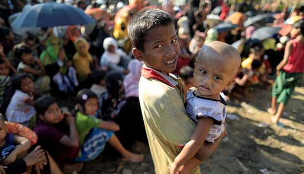 Rohingya refugees wait for humanitarian aid to be distributed at the Balukhali refugee camp in Cox's Bazar, Bangladesh. Reuters