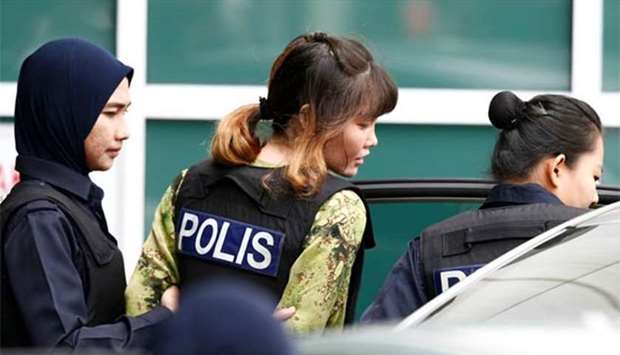 Vietnamese Doan Thi Huong. who is on trial for the killing of Kim Jong Nam, is escorted by police in Petaling Jaya, near Kuala Lumpur.