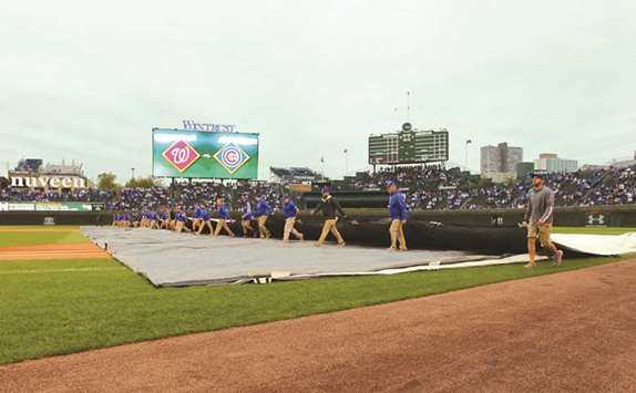 Chicago Cubs grounds crew roll out the tarp before game four of the 2017 NLDS playoff baseball series against the Washington Nationals at Wrigley Field. (USA TODAY Sports)