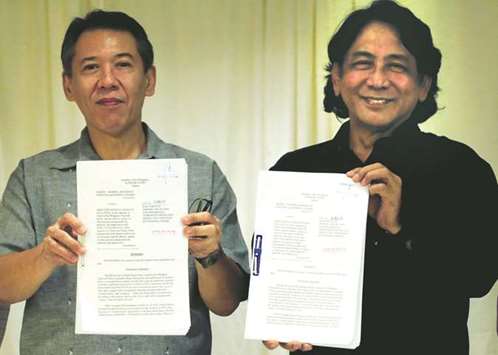 Lawyers Jose Manuel Diokno and Felix Marinas from the Free Legal Assistance Group (FLAG), show documents during a news conference in Metro Manila, yesterday.