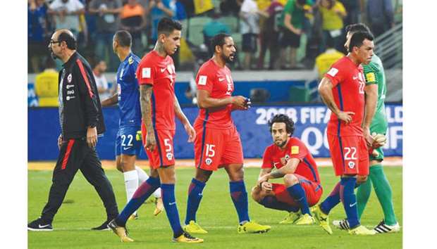 Chile players are dejected after they missed out on a World Cup place after losing to Brazil in Sao Paulo, Brazil. (AFP)