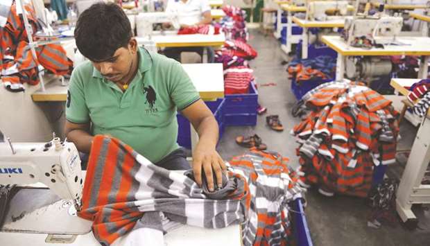 Men work at a garment factory in Ludhiana.