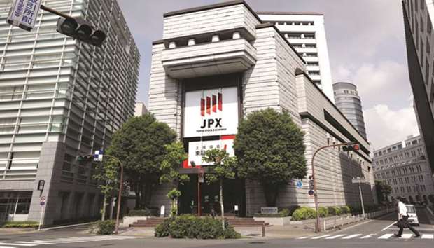 The Tokyo Stock Exchange building (centre) in Tokyo. Japanu2019s main stock index Nikkei finished at its highest in more than two decades yesterday, leading broad gains across Asian equities following another record Wall Street close.