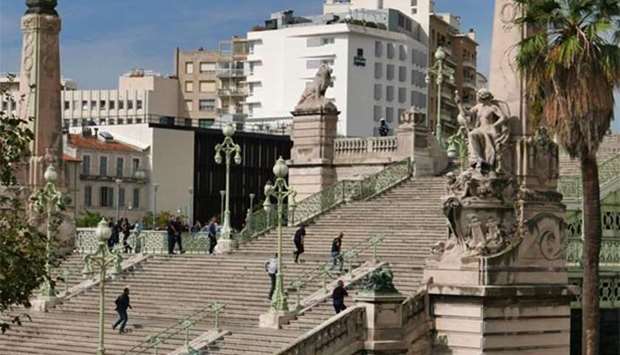 French police are seen on the stairs leading to the Saint-Charles main train station in Marseille, after a man armed with a knife killed two people on Sunday.