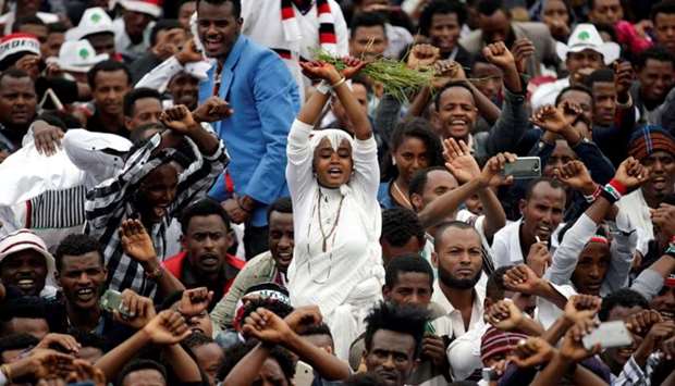 A demonstrator chants slogans while flashing the Oromo protest gesture during celebrations for Irreecha, the thanksgiving festival of the Oromo people, in Bishoftu town, Oromia region, Ethiopia
