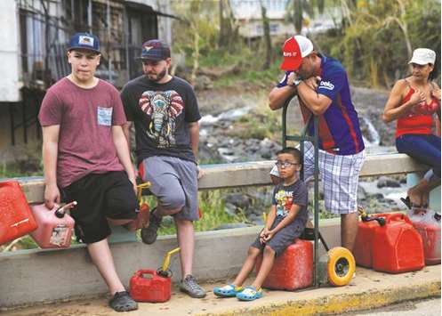 Residents affected by Hurricane Maria wait in line for fuel donated by the Fuel Relief Fund in the municipality of Orocovis, outside San Juan, Puerto Rico.