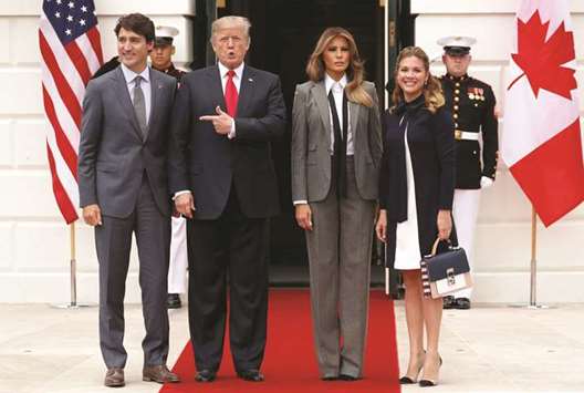 US President Donald Trump and First Lady Melania Trump welcome Canadau2019s Prime Minister Justin Trudeau and his wife Sophie Gregoire Trudeau on the South Lawn before the leadersu2019 meeting on the Nafta trade agreement at the White House in Washington, US, yesterday.
