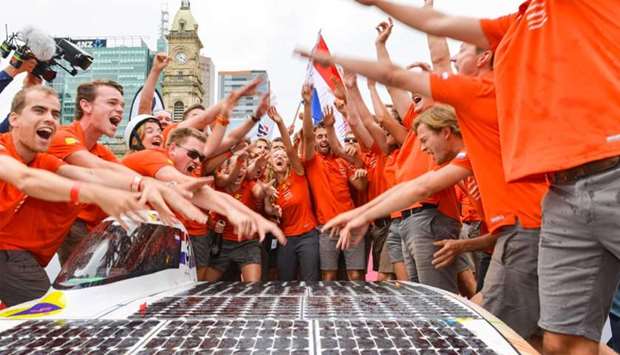 Crew members of the Dutch team ,Nuon, celebrate after winning in the World Solar Challenge