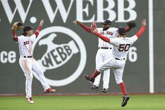 Boston Red Sox players celebrate after clinching the American League East with a win over Houston Astros in Boston, Massachusetts, on Saturday. (USA TODAY Sports)